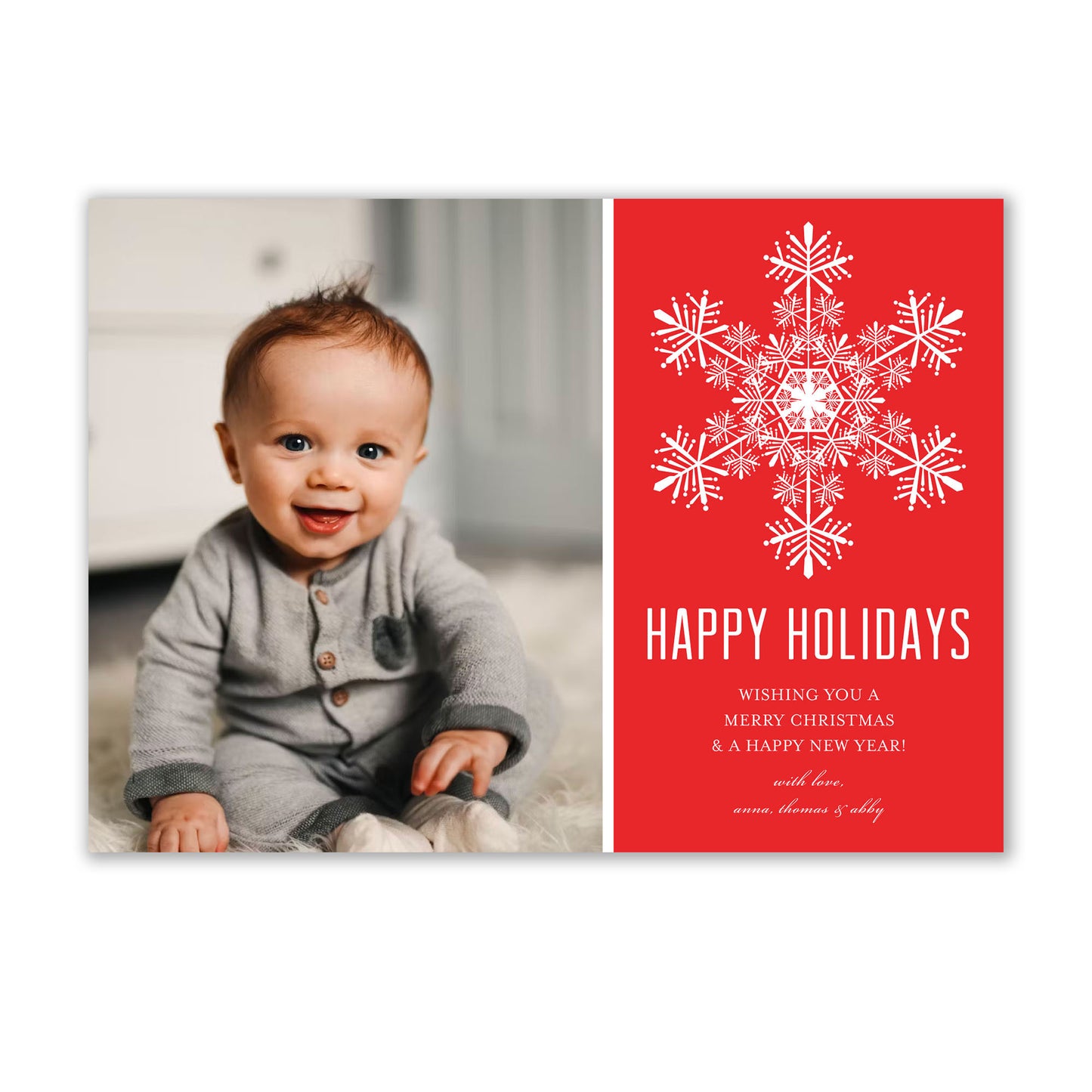 An Elegant Snowflake Holiday Photo Cards baby sitting on the floor. (Brand Name: Noteworthy)