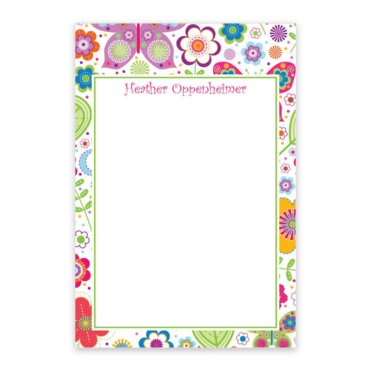 The Spring Butterfly Personalized Notepad by Noteworthy features a blank floral design with a vibrant border and your name in pink at the top—perfect for jotting down notes.