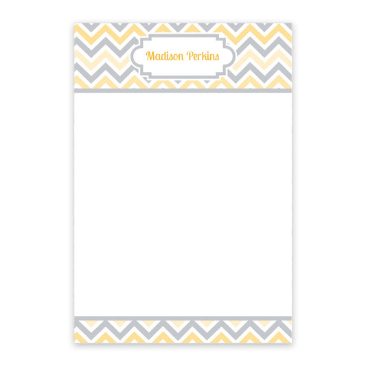 The Noteworthy Multi Yellow Chevron Personalized Notepad features a stylish yellow and gray chevron border with "Madison Perkins" elegantly printed at the top in yellow text.