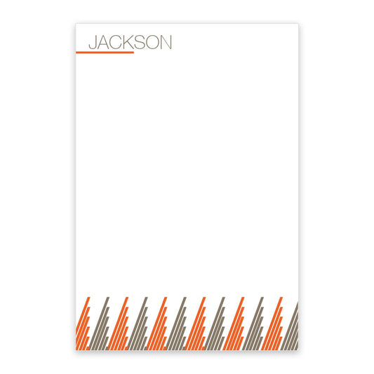 The Noteworthy Pixel Stripes Personalized Notepad features 100 sheets, "JACKSON" at the top left, an orange line below, and orange and gray pixel stripes at the bottom; the rest of the orange notepad is blank for your notes.
