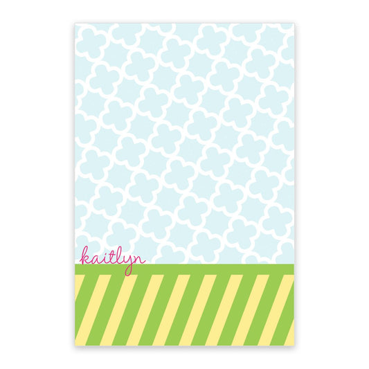 The Preppy & Bold Personalized Notepad by Noteworthy features a light blue quatrefoil design, green and yellow stripes, and "kaitlyn" in pink script—an ideal way to add charm to your notes.