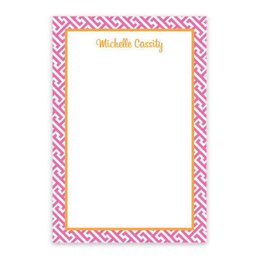The Noteworthy Pink Geometric Pattern Personalized Notepad features a stylish white and orange border and “Michelle Cassity” scripted in orange at the top.