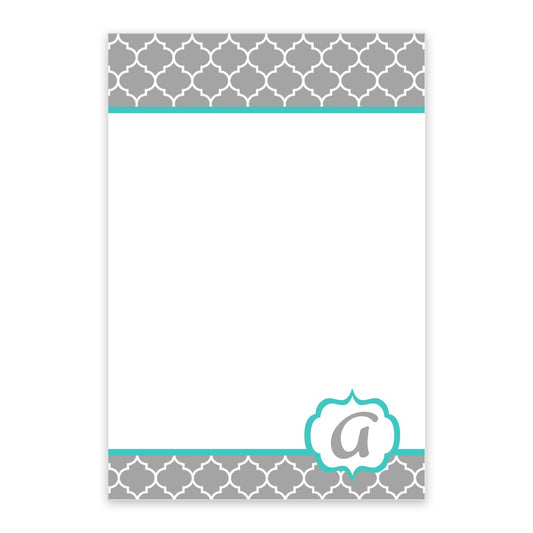 The Noteworthy Gray Lattice Pattern Personalized Notepad features a turquoise center, gray and white geometric border, teal accents, and a lowercase “a” in a decorative frame at the bottom. Includes 100 blank sheets for notes.