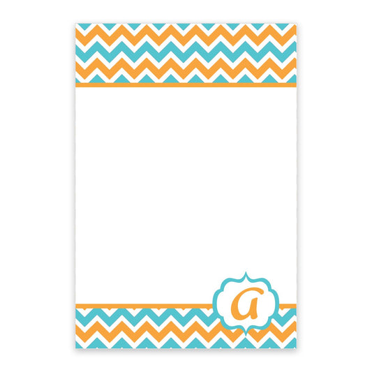 The Noteworthy Teal and Orange Chevron Pattern Personalized Notepad features a white background, chevron borders in teal and orange, and a decorative “a” in the lower right corner.