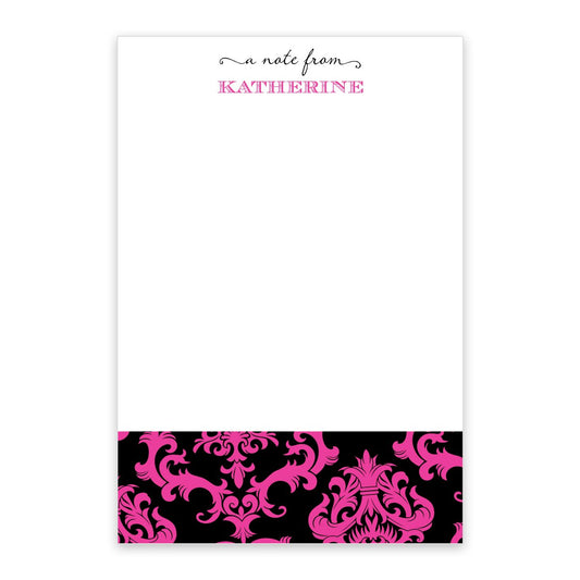 The Noteworthy Hot Pink on Black Toile Personalized Notepad features "a note from KATHERINE" at the top and a decorative black and hot pink toile pattern along the bottom.
