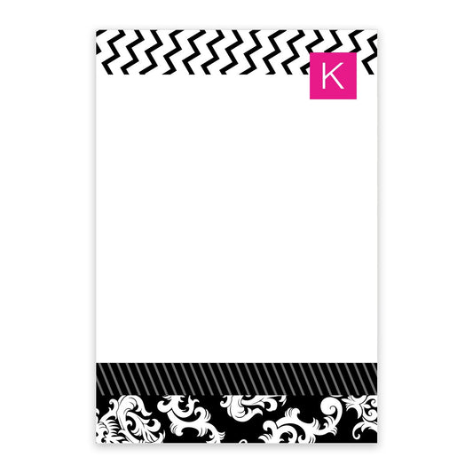 The Noteworthy Black and Pink Initial Personalized Notepad features a modern white design with a black chevron zigzag, a pink initial "K" at the top, and an ornate black-and-white pattern at the bottom.