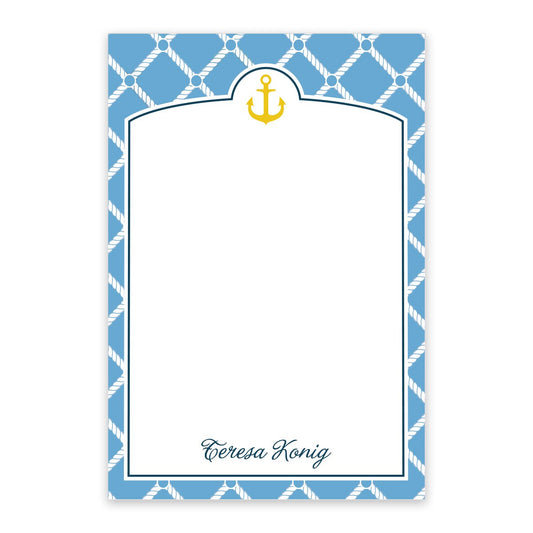 The Noteworthy Anchor Personalized Notepad features a blue and white nautical design with a rope border, yellow anchor at the top, “Teresa Konig” at the bottom, and a blank space for writing.