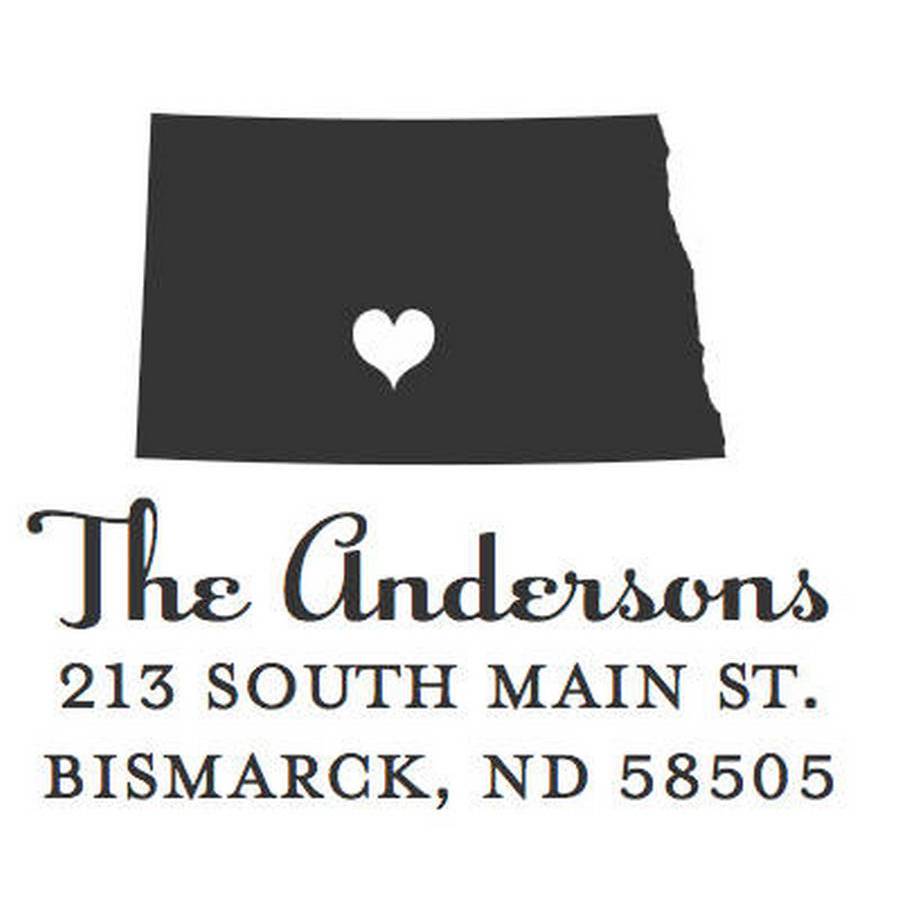 The Noteworthy Capital of North Dakota Square Stamper or Embosser features a heart-centered North Dakota outline above “The Andersons, 213 South Main St., Bismarck, ND 58505.” Ideal for personalized stationery or custom Bismarck address stamps.