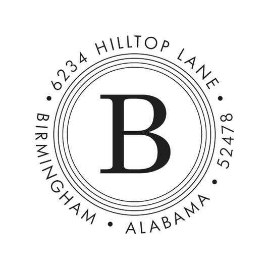 The Quad Circle Initial Stamper or Embosser by Noteworthy features a bold central "B" encircled by "6234 Hilltop Lane, Birmingham, Alabama 52478." Ideal for those seeking designer self-inking stamps with a personalized touch.
