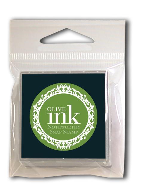 The Noteworthy Olive Green Snap Stamper Ink Pad Refill features a green decorative circle on the package, perfect for adding olive green ink to your crafts—no extra cartridges needed.