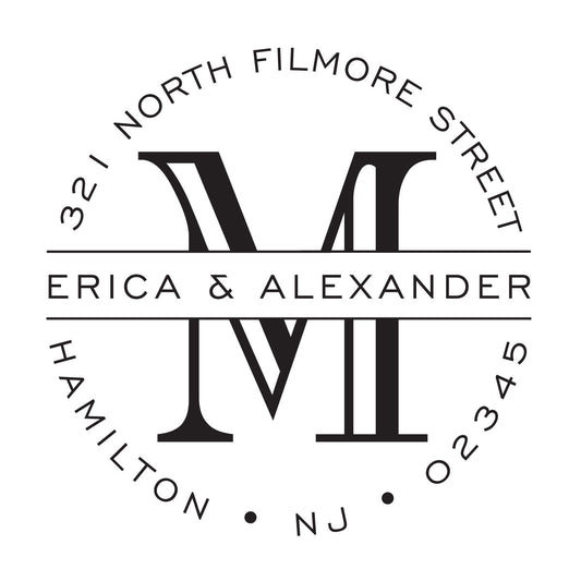 The Noteworthy Banded Initial Stamper or Embosser features a bold black and white “M” monogram, “Erica & Alexander,” and “321 North Filmore Street, Hamilton, NJ 02345” in a circular design—ideal for personalizing stationery.