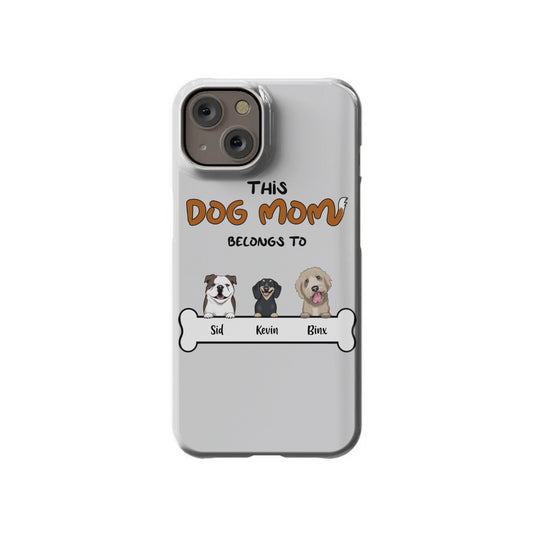 Display your dog mom pride with the Custom Dog Mom iPhone 14 Slim Case from InvitationBox.com, featuring "This Dog Mom Belongs To," cute dog caricatures of Sid, Kevin, and Binx, plus a fun bone graphic.