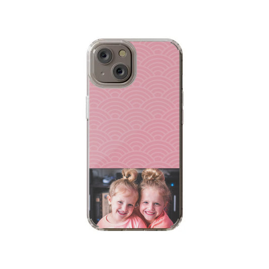 The InvitationBox.com Custom Pattern Top with Photo iPhone 14 Clear Case features a clear design, a pink geometric pattern on top, and your chosen photo—like two smiling kids in matching pink shirts—at the bottom.