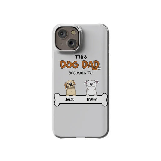 The Custom Dog Dad iPhone 14 Slim Case by InvitationBox.com features caricatures of two dogs labeled "Jacob" and "Tristan" with the phrase "This Dog Dad Belongs To.
