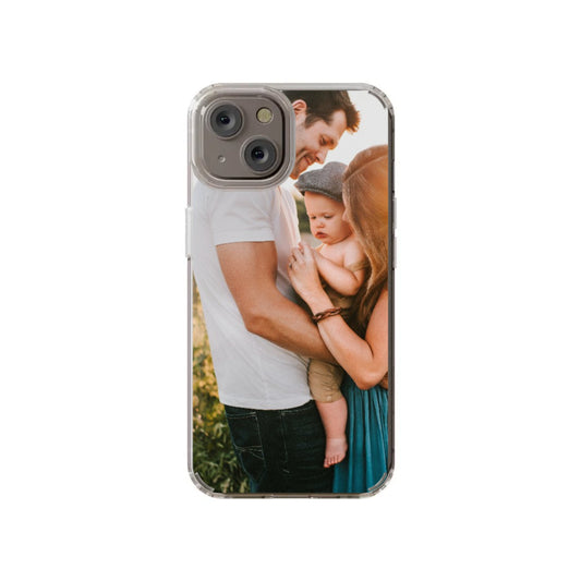 The InvitationBox.com Custom Full Photo iPhone 14 Clear Case displays your chosen photo, such as two adults and a baby smiling outdoors, for a unique, personalized touch.